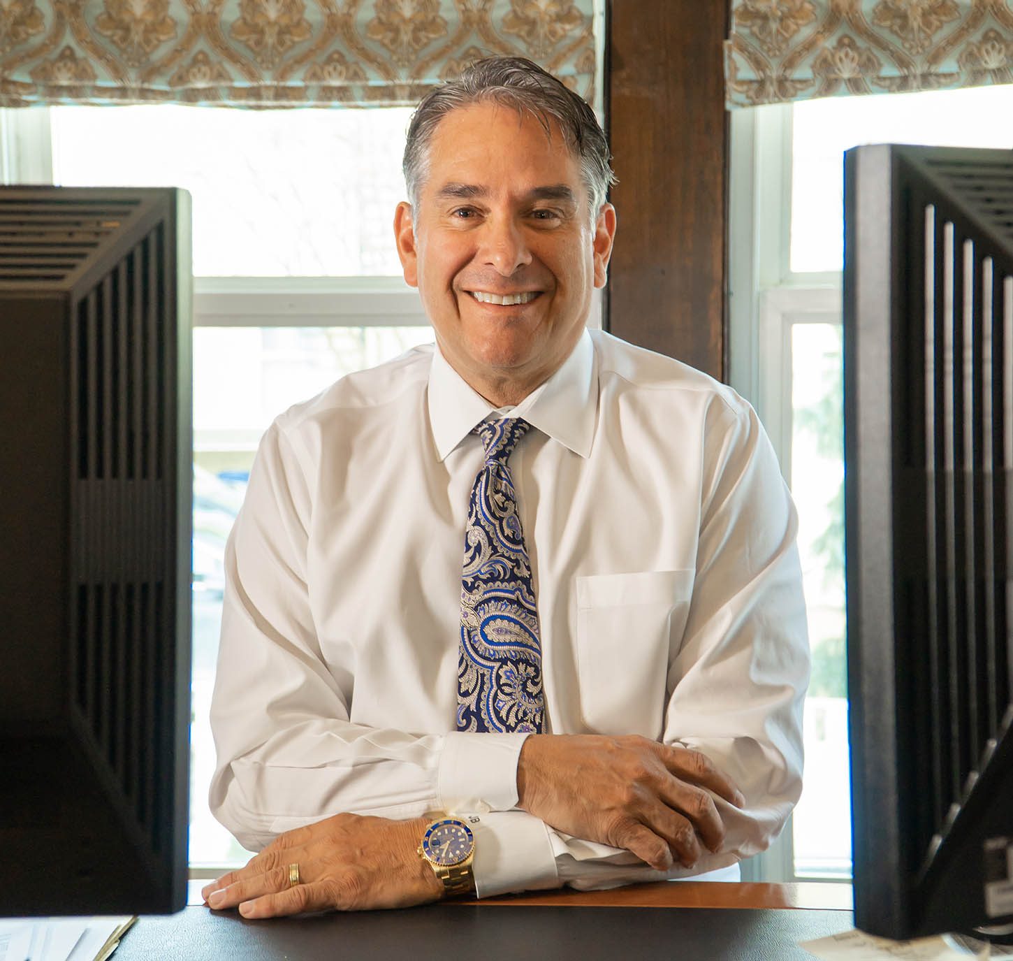 John K. Bosen Smiling at his desk